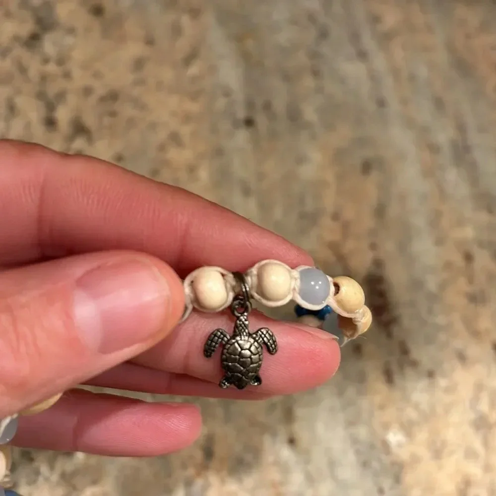 Kids beaded necklace with a silver turtle at the bottom of the necklace